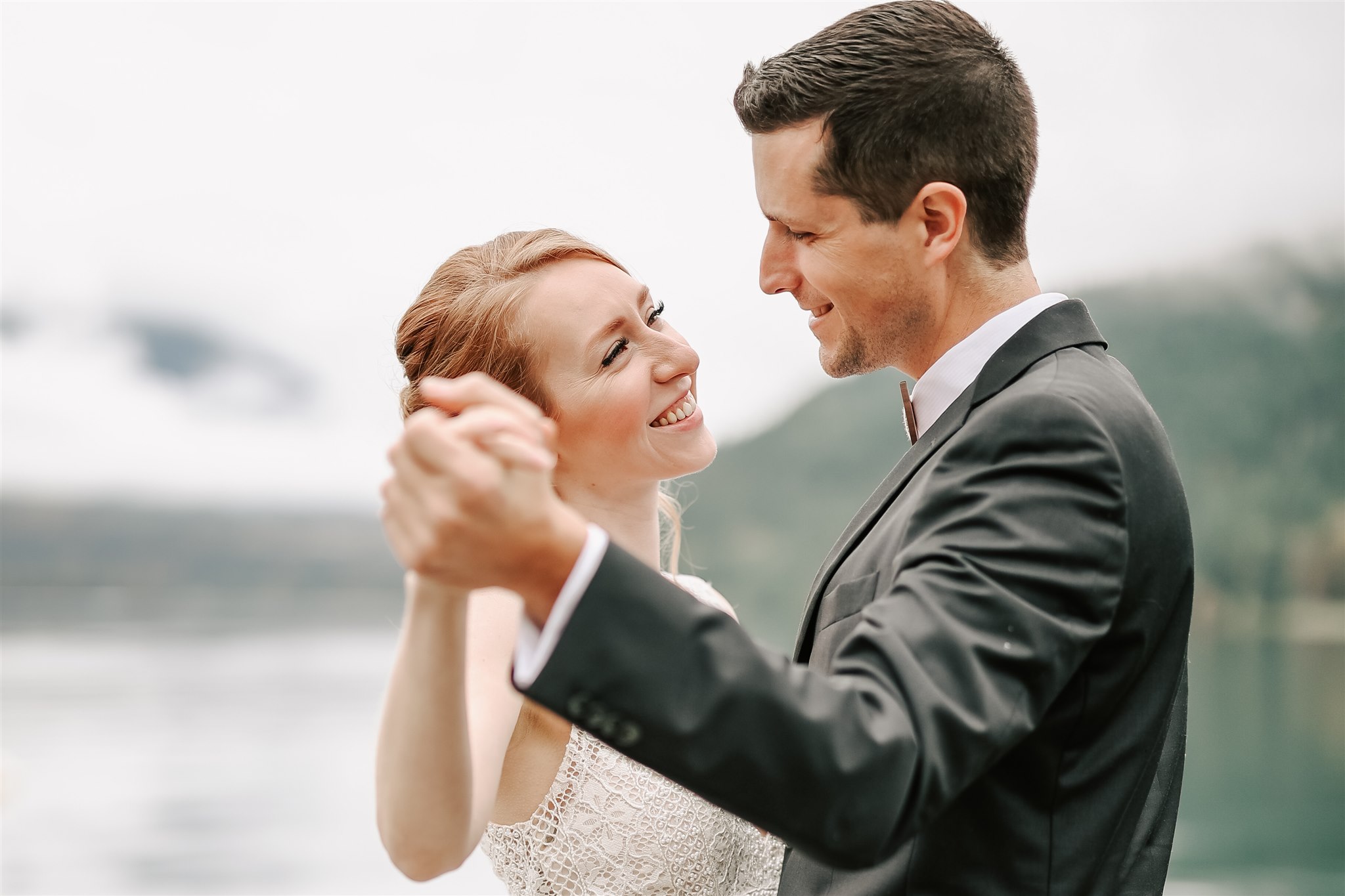 bride and groom dancing on a dock