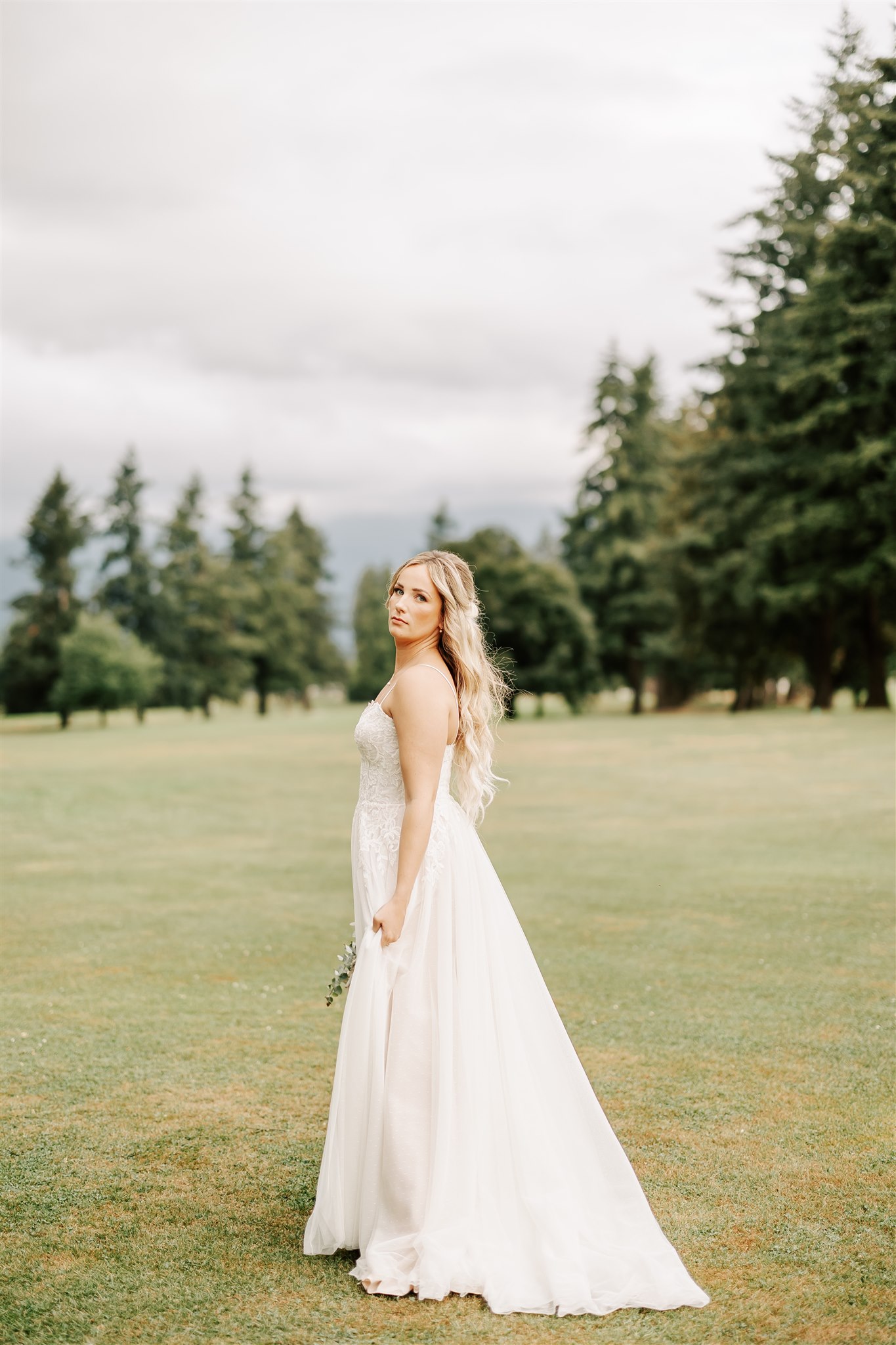 bride standing on the fairway of the golden eagle golf club wedding venue