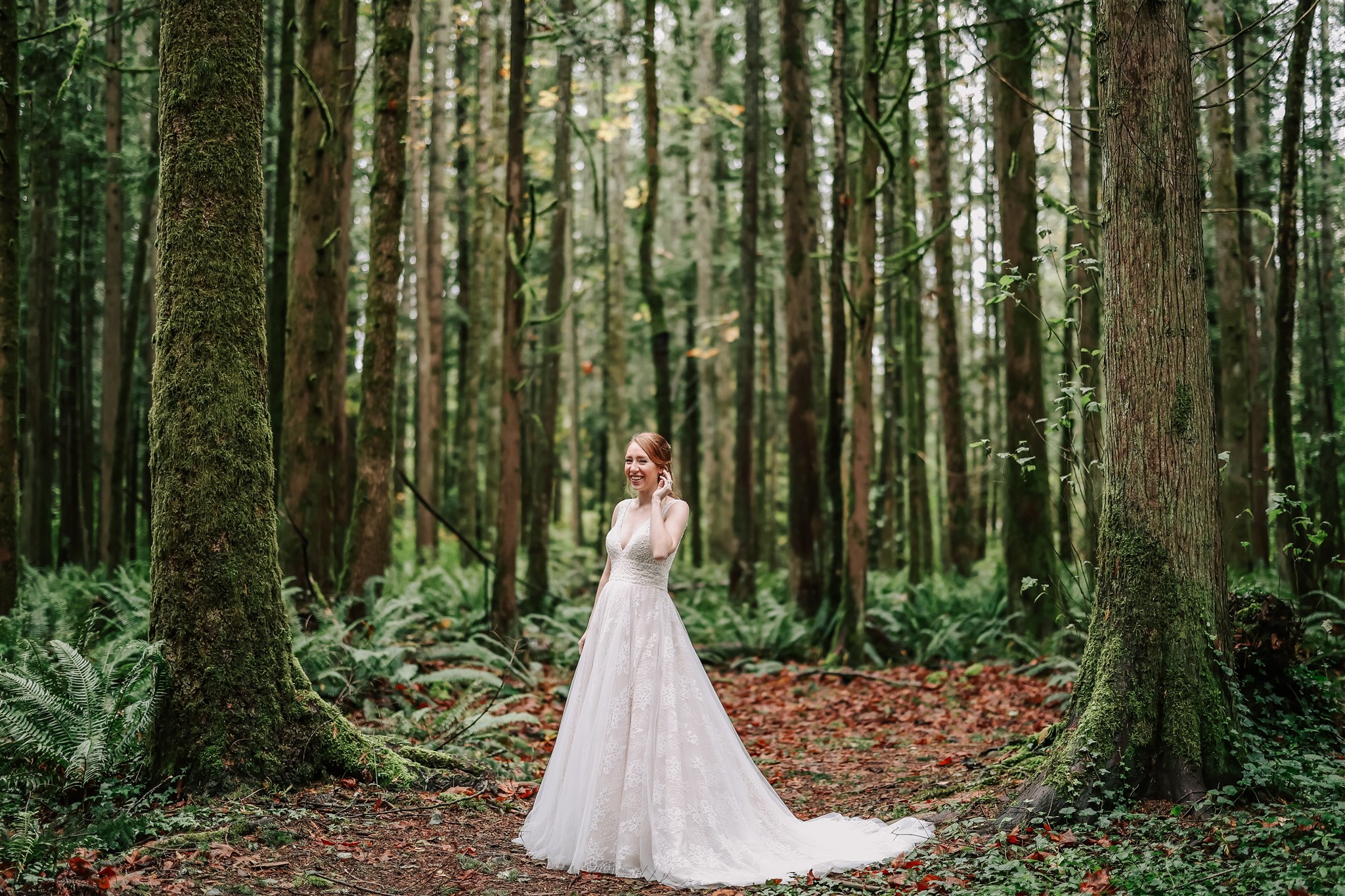 bride standing in the middle of the forest surrounded by trees Vancouver Wedding Planners