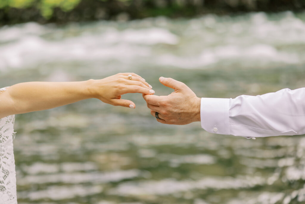Sweet editorial detail of hands touching during a wedding portrait by Vedder River 
